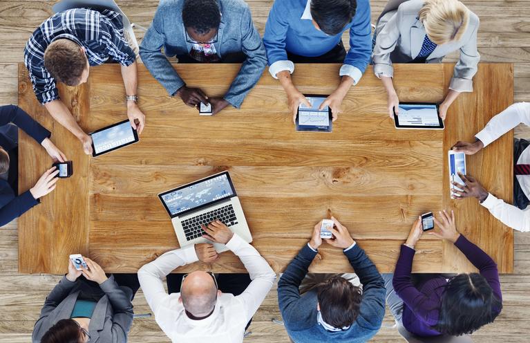 Coworkers around a conference table working.